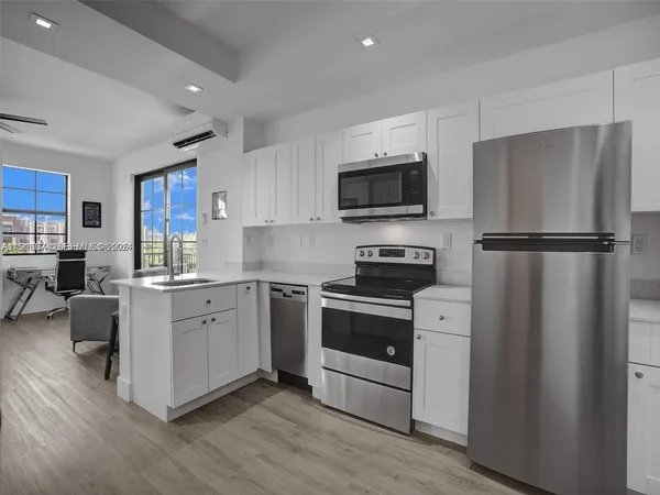 a kitchen with a refrigerator stove and sink