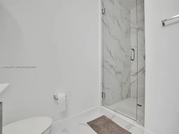 a bathroom with a shower and toilet