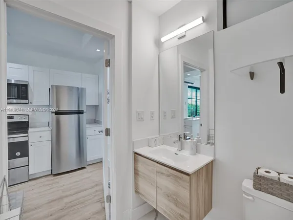 a bathroom with a sink a mirror and a shower