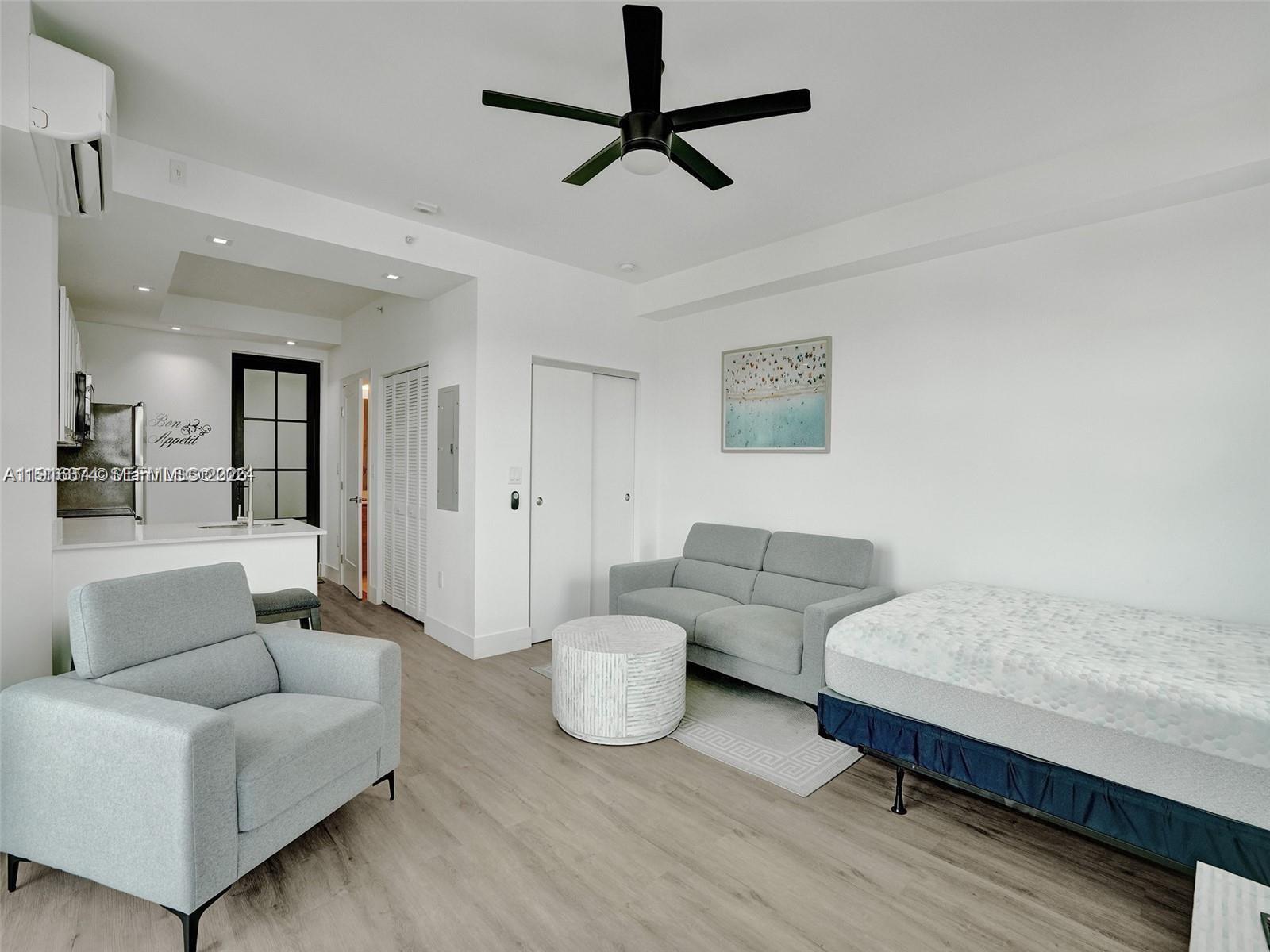 4100 Southwest 64th Avenue, Unit 308 Davie, FL 33314 - Photo 17 of 41 a living room with furniture and a wooden floor