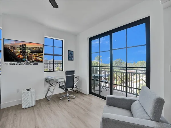 a living room with furniture window and a flat screen tv