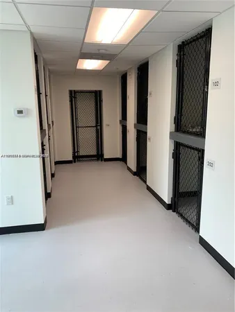 a room with gym equipment and a wooden floor