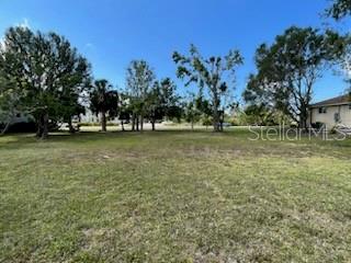 310 West Henry Street Punta Gorda, FL 33950 - Photo 14 of 24 a view of a field with trees in the background