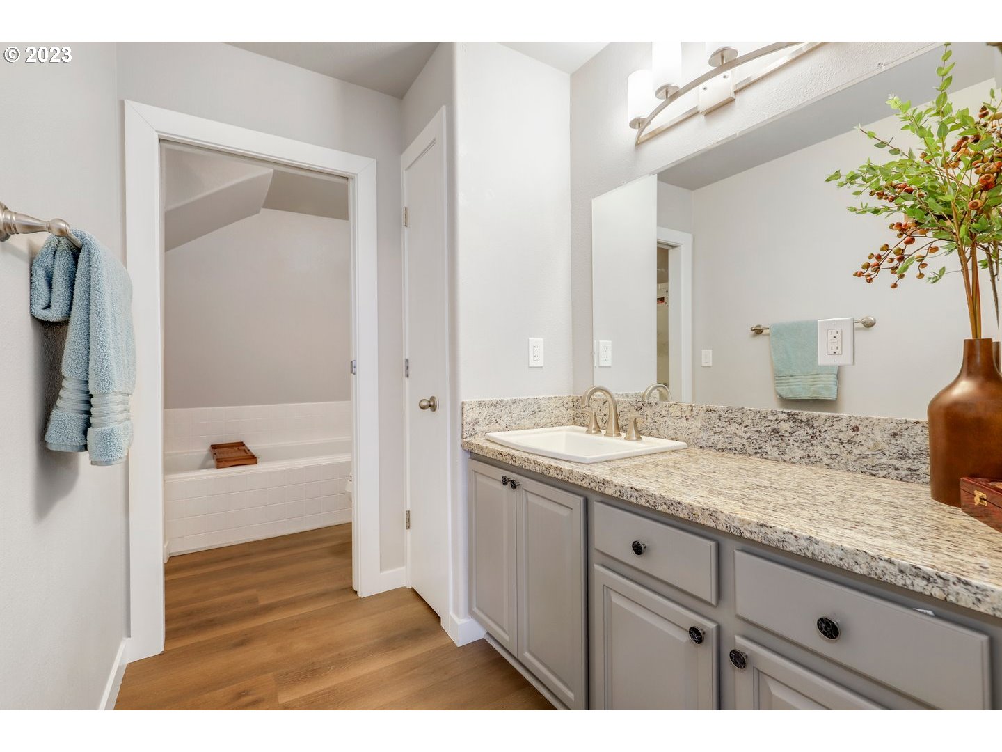 4114 Nicholson Road Vancouver, WA 98661 - Photo 18 of 28 a bathroom with a granite countertop sink a mirror and a bathtub