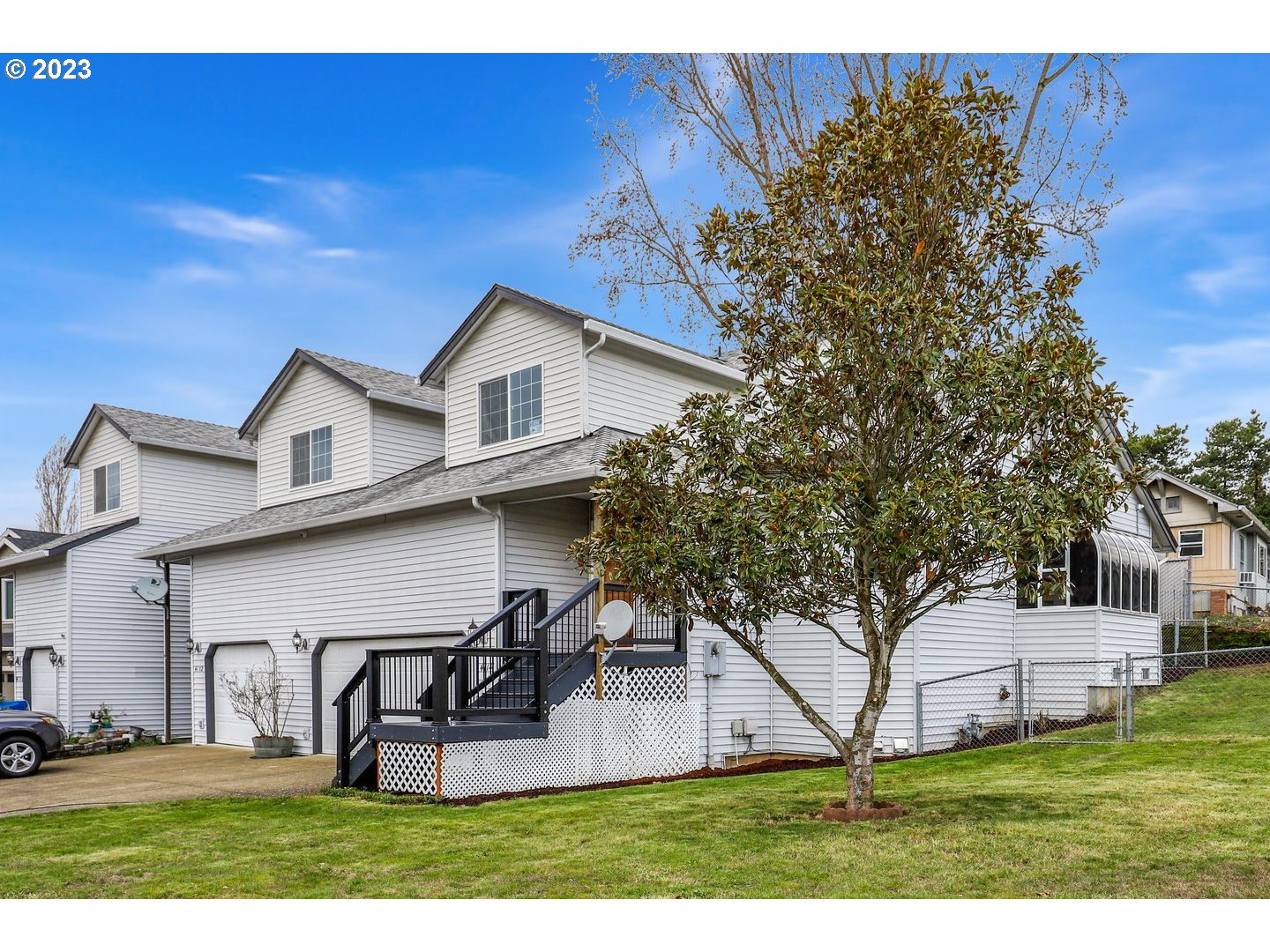 4114 Nicholson Road Vancouver, WA 98661 - Photo 2 of 28 a view of a white house with a big yard and large trees