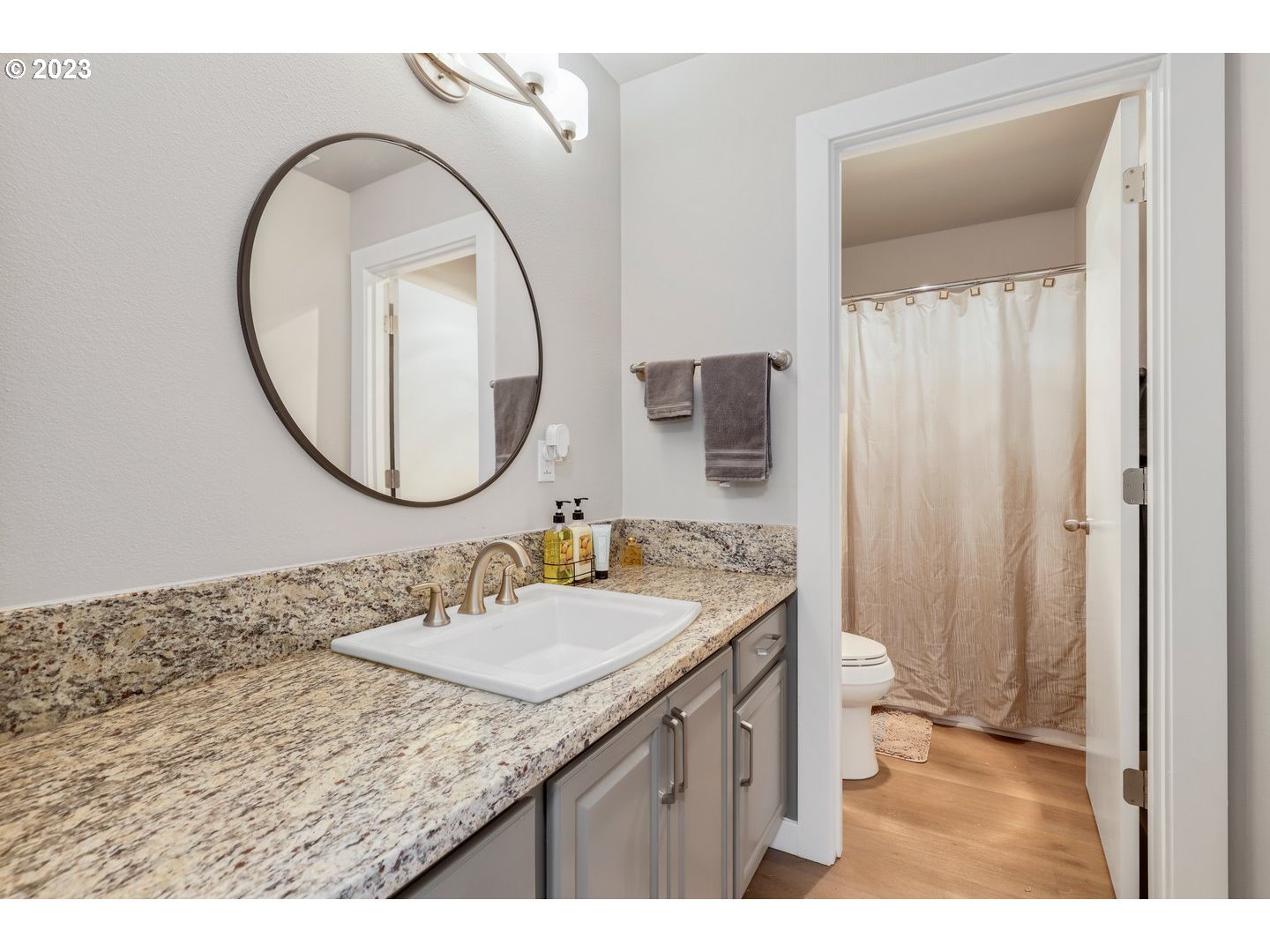 4114 Nicholson Road Vancouver, WA 98661 - Photo 24 of 28 a bathroom with a granite countertop sink a mirror and a toilet