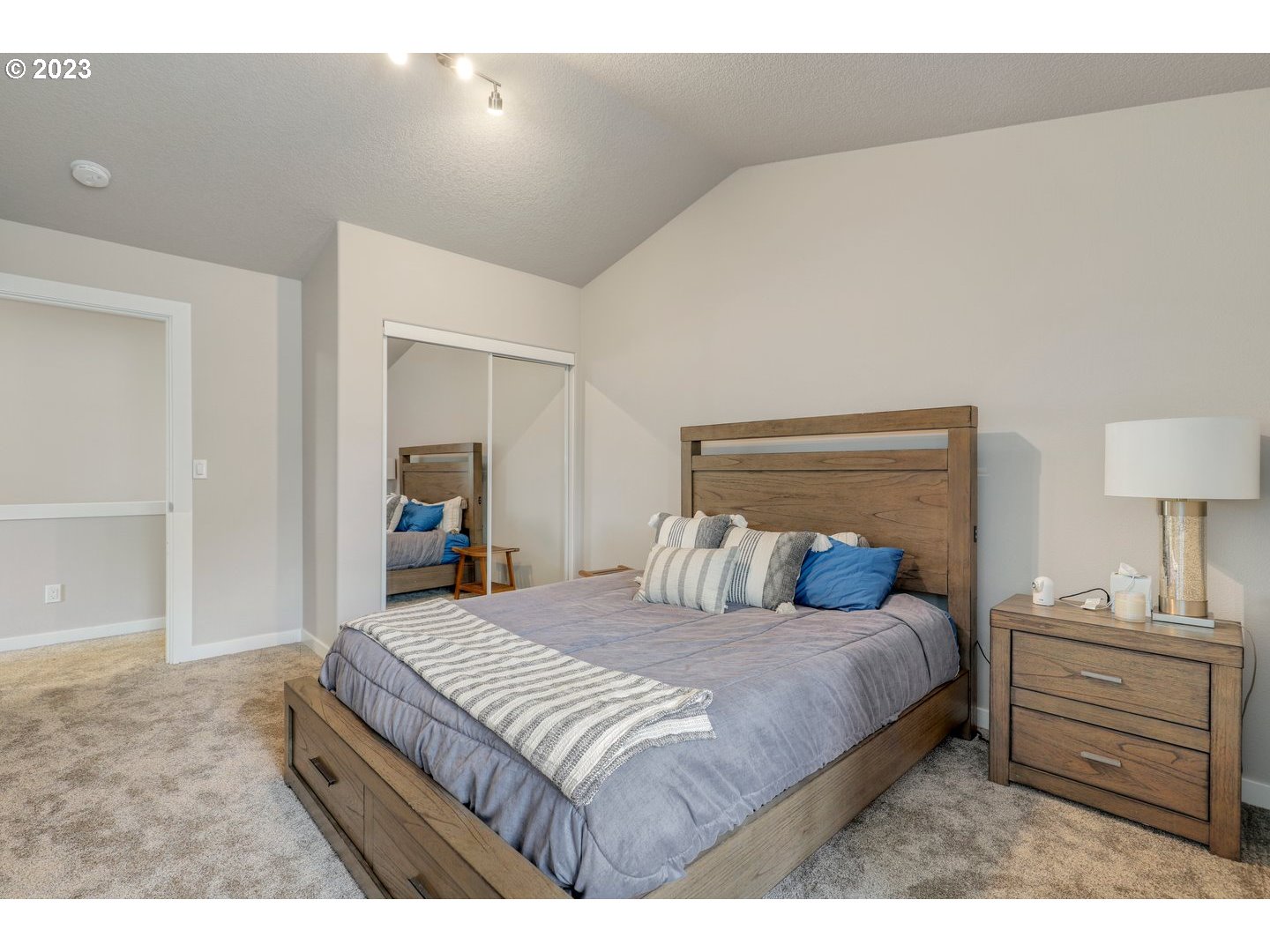 4114 Nicholson Road Vancouver, WA 98661 - Photo 28 of 28 a bedroom with a bed and a lamp on dresser