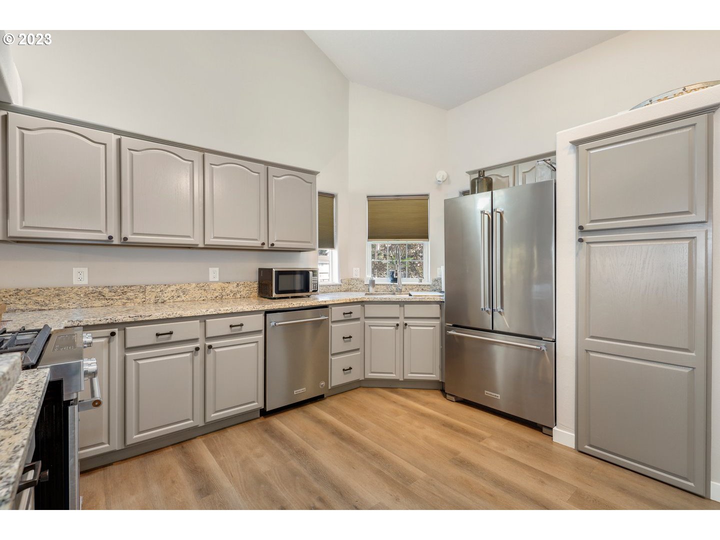 4114 Nicholson Road Vancouver, WA 98661 - Photo 7 of 28 a kitchen with granite countertop stainless steel appliances a refrigerator a sink and cabinets