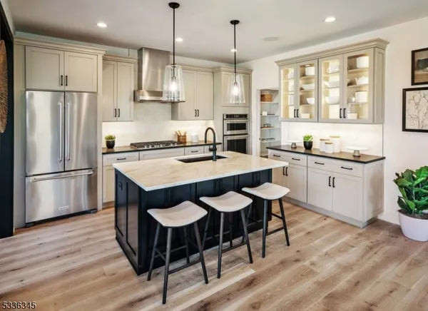 a kitchen with granite countertop a sink appliances a counter space and a center island