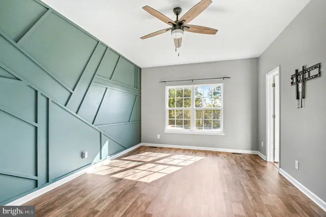 a view of a livingroom with a ceiling fan and window