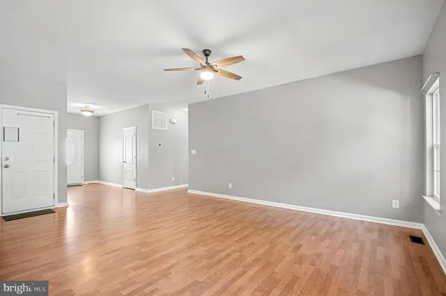 a view of an empty room with wooden floor