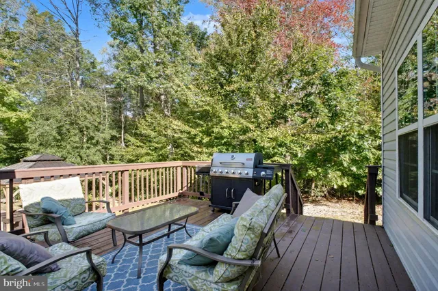 a view of balcony with wooden floor and outdoor seating