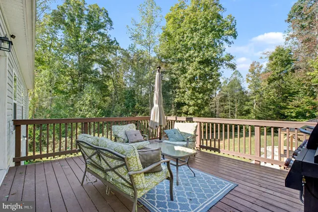 a view of balcony with wooden floor and outdoor seating