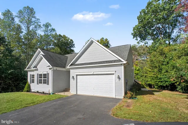 a view of a house with a yard and garage