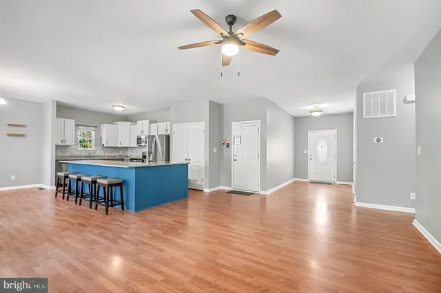 a view of kitchen and kitchen with furniture appliances