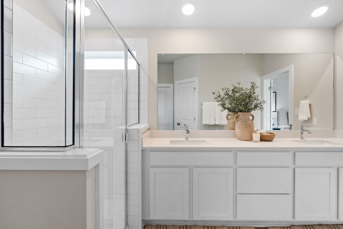 21701 Oregon Lane Leander, TX 78645 - Photo 22 of 31 a bathroom with a double vanity sink and mirror