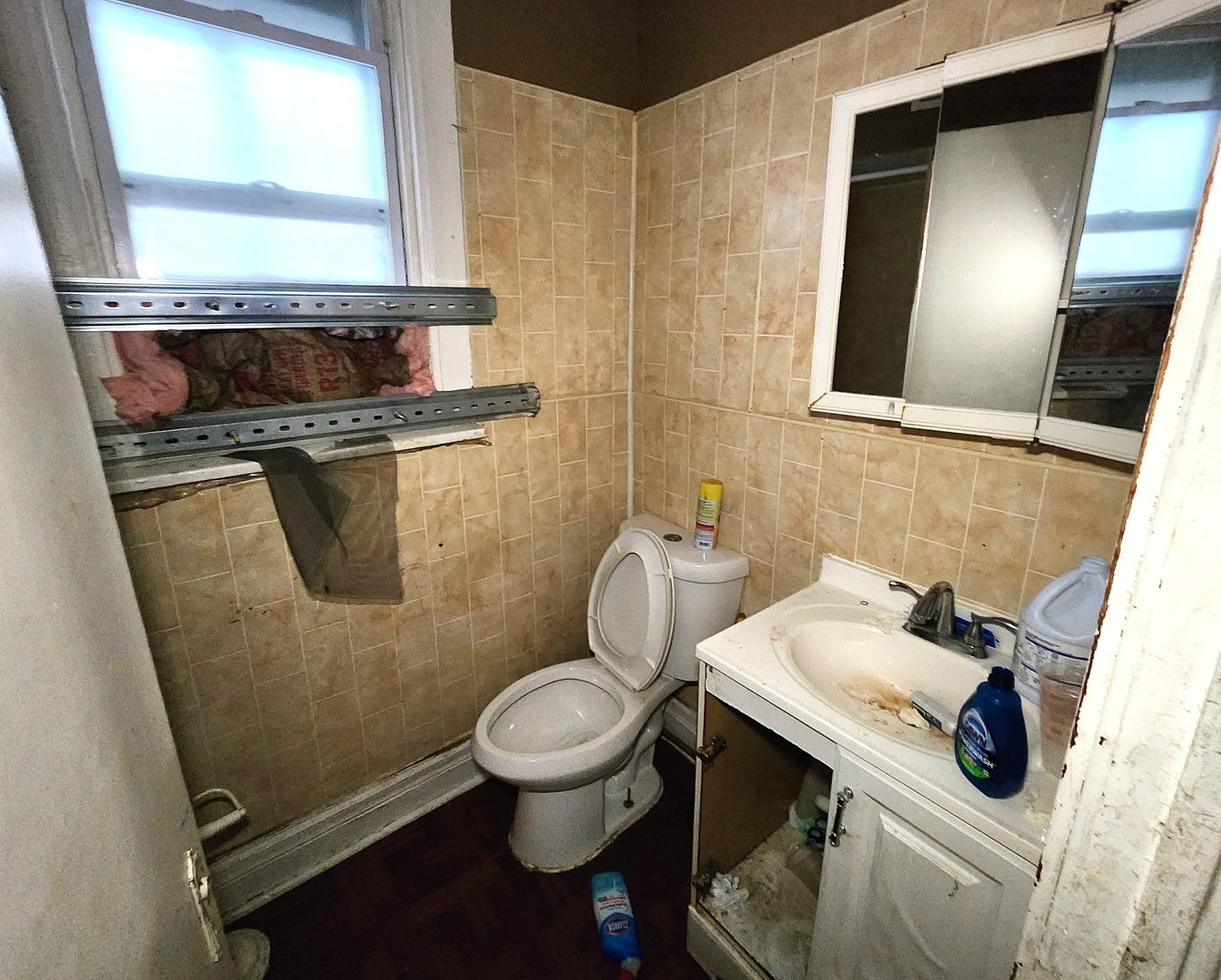 10623 South Perry Avenue Chicago, IL 60628 - Photo 9 of 13 a bathroom with a sink and a toilet