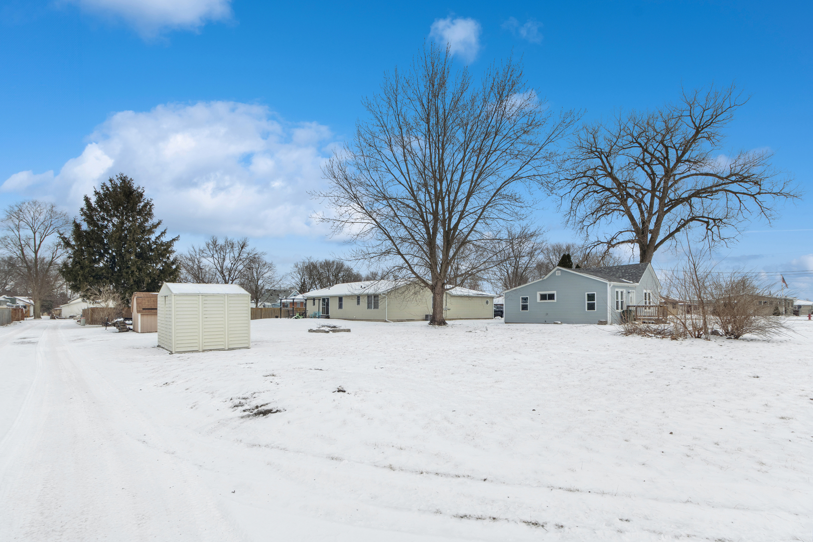 411 East Mazon Street Gardner, IL 60424 - Photo 20 of 21 a view of white house with a yard covered in snow
