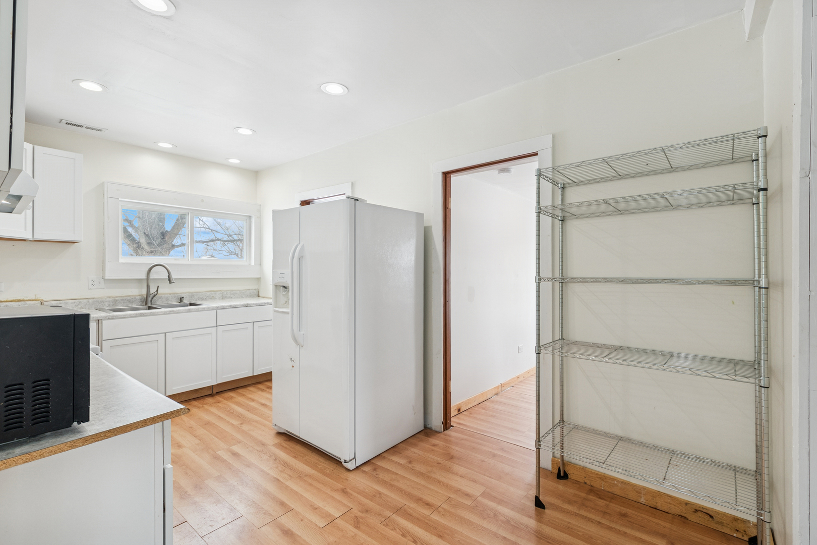 411 East Mazon Street Gardner, IL 60424 - Photo 7 of 21 a kitchen with a refrigerator a sink and a stove top oven