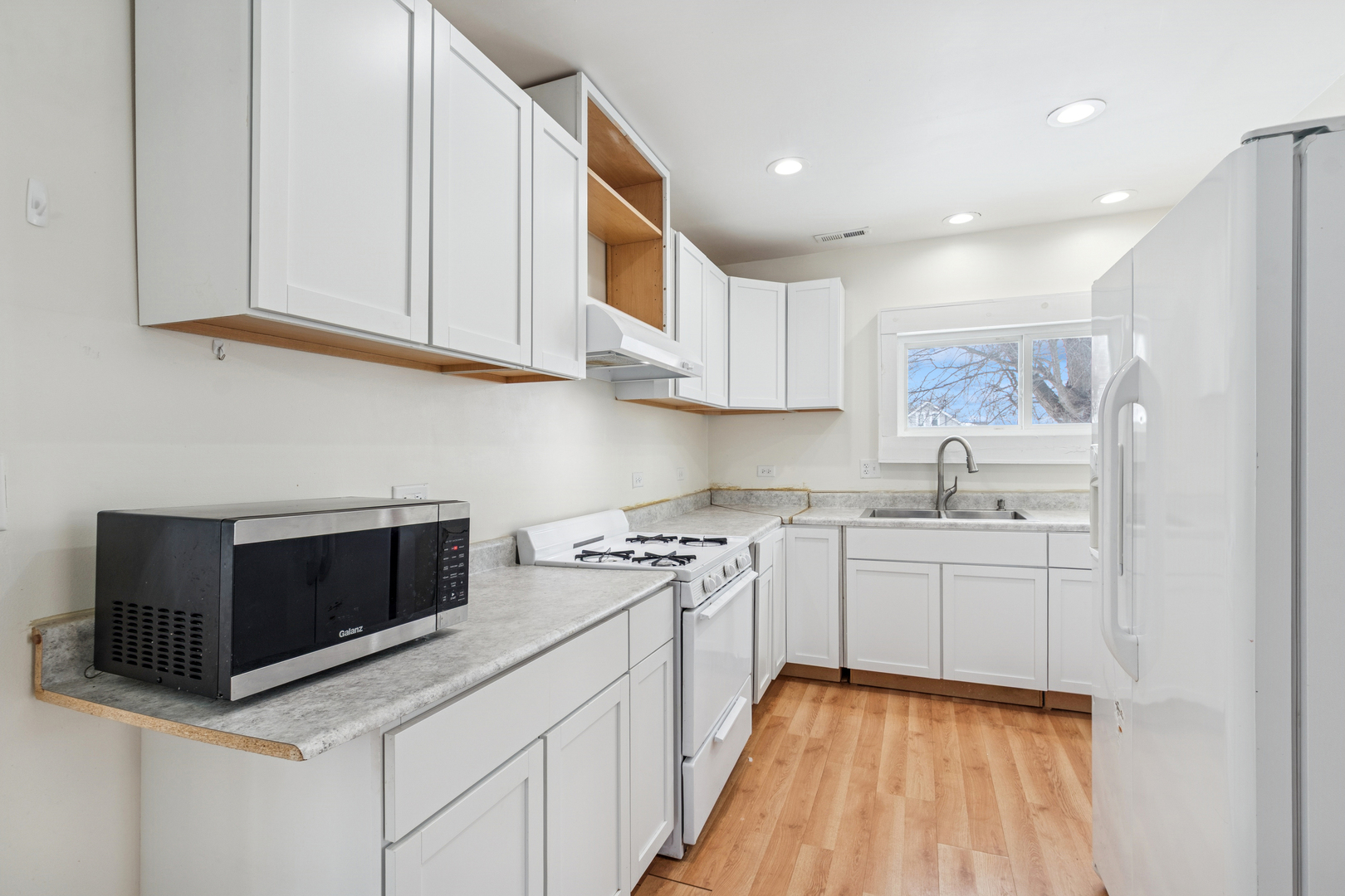 411 East Mazon Street Gardner, IL 60424 - Photo 8 of 21 a kitchen with stainless steel appliances granite countertop a stove a sink and a microwave