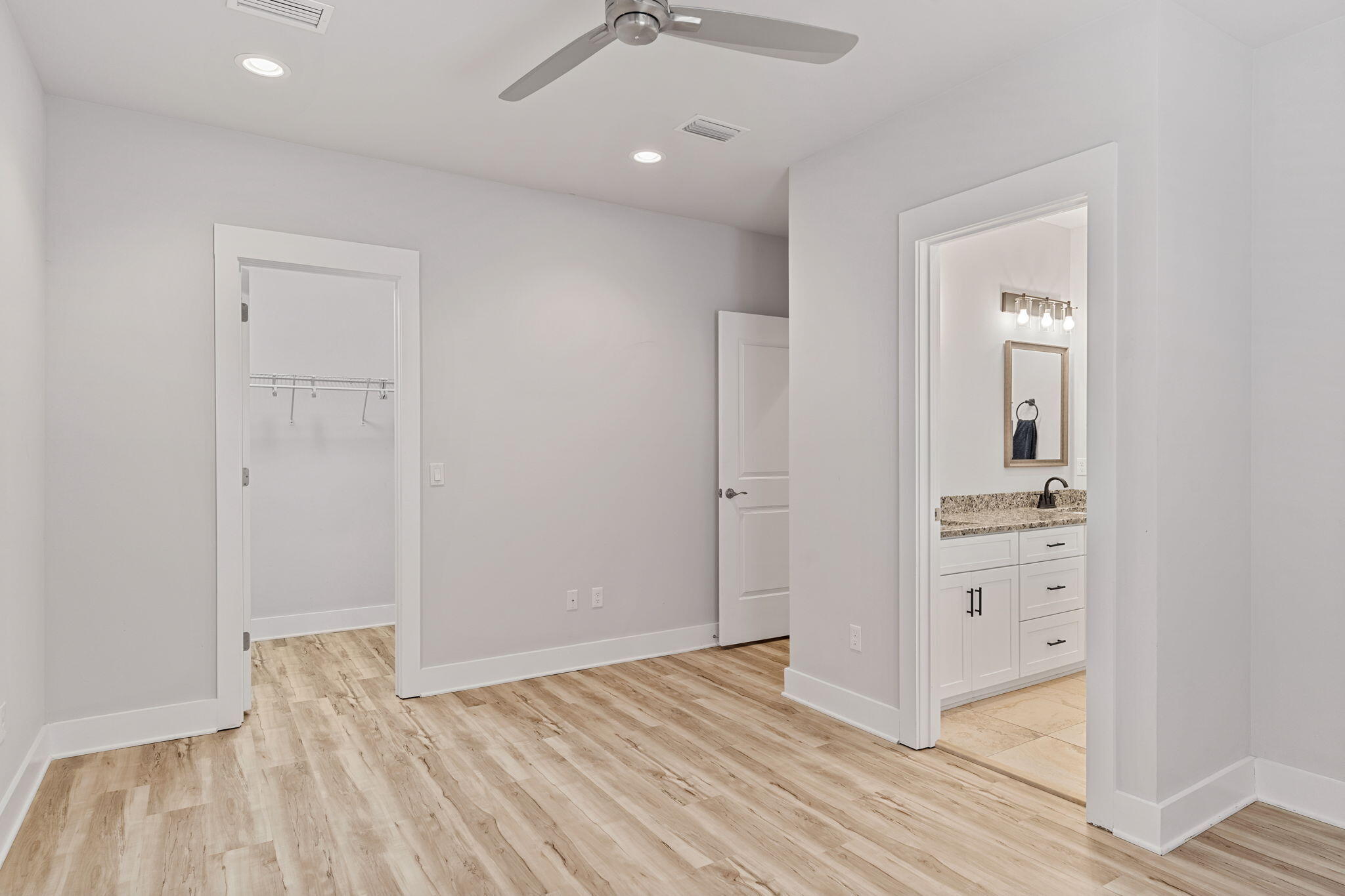 995 Airport Road, Unit 43 Destin, FL 32541 - Photo 26 of 40 wooden floor in an empty room with a mirror
