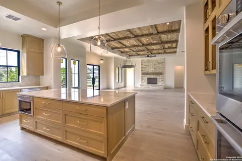 a large kitchen with kitchen island granite countertop a large window
