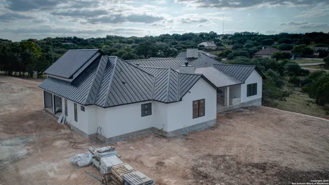 an aerial view of a house with a yard and balcony