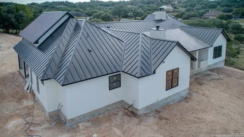 a view of a house with backyard and deck