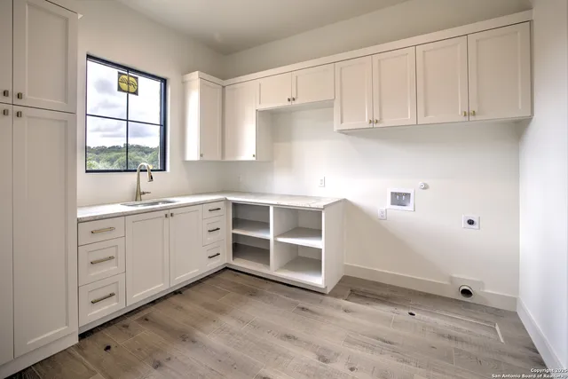 a kitchen with white cabinets and white appliances