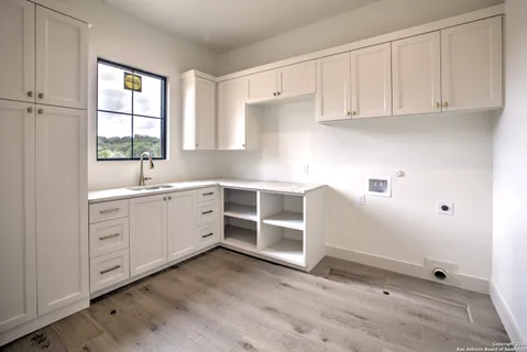 a kitchen with white cabinets and white appliances