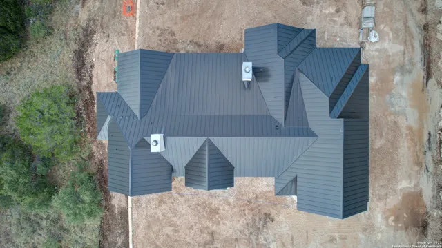 a view of house with stairs and large tree