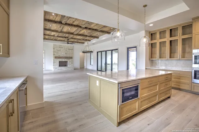 a kitchen with stainless steel appliances granite countertop a stove and a kitchen island