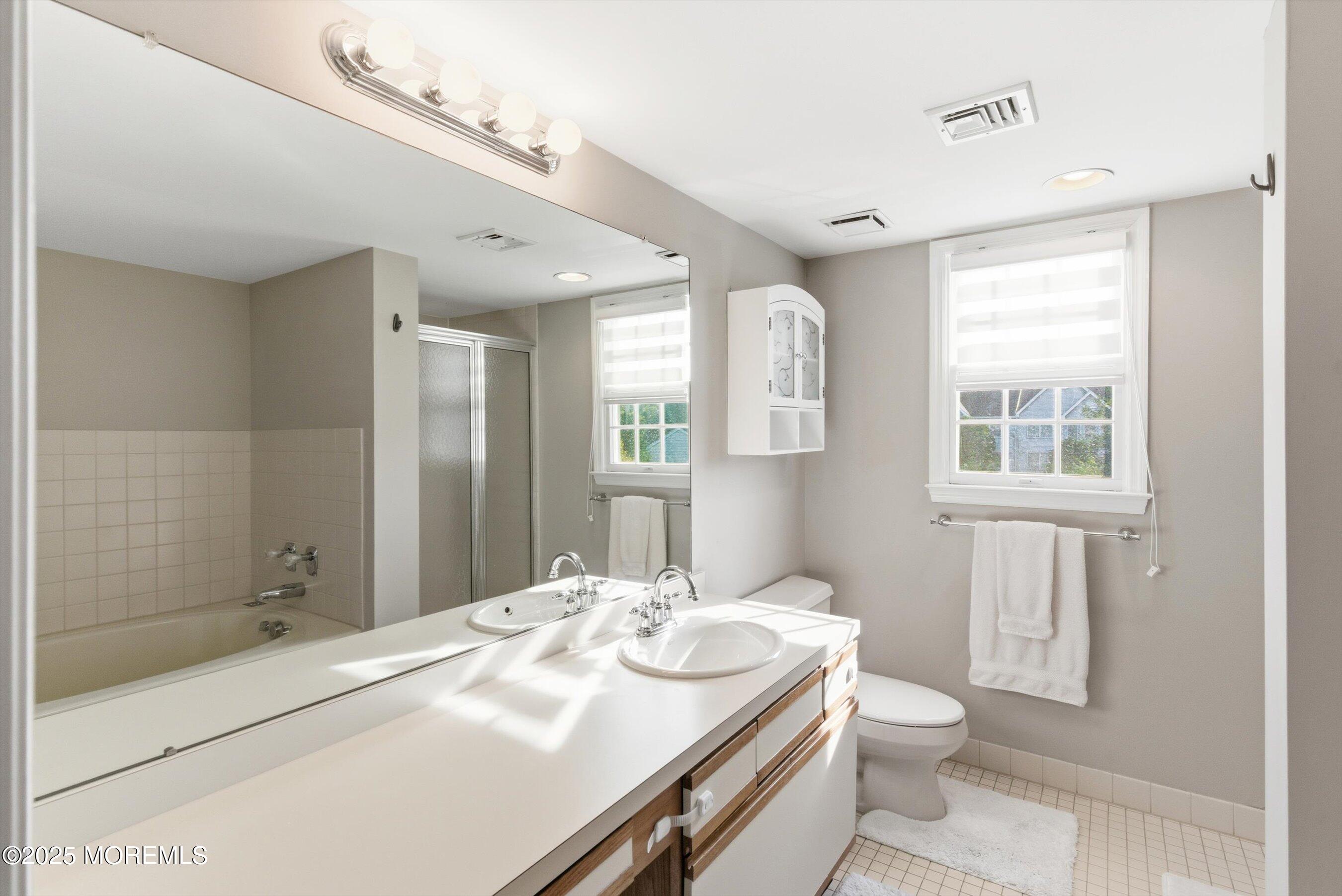 122 Quartz Lane Paterson, NJ 07501 - Photo 19 of 34 a bathroom with a sink a toilet and shower