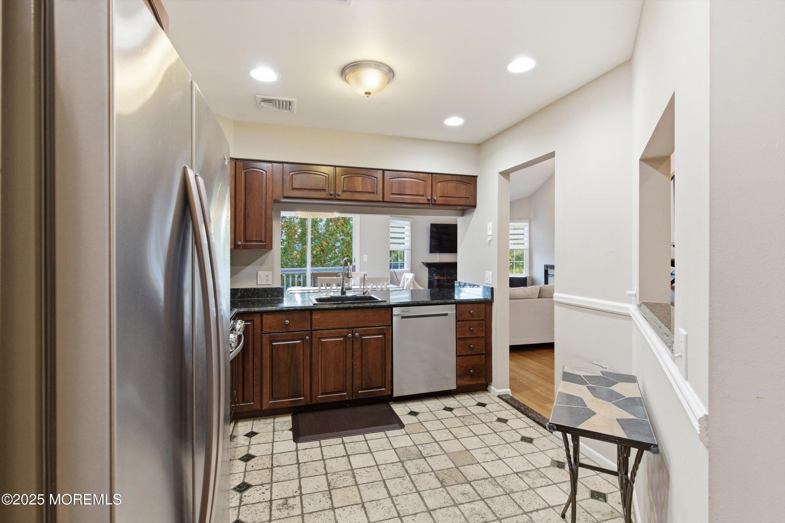 122 Quartz Lane Paterson, NJ 07501 - Photo 21 of 34 a kitchen with stainless steel appliances granite countertop a refrigerator and a sink