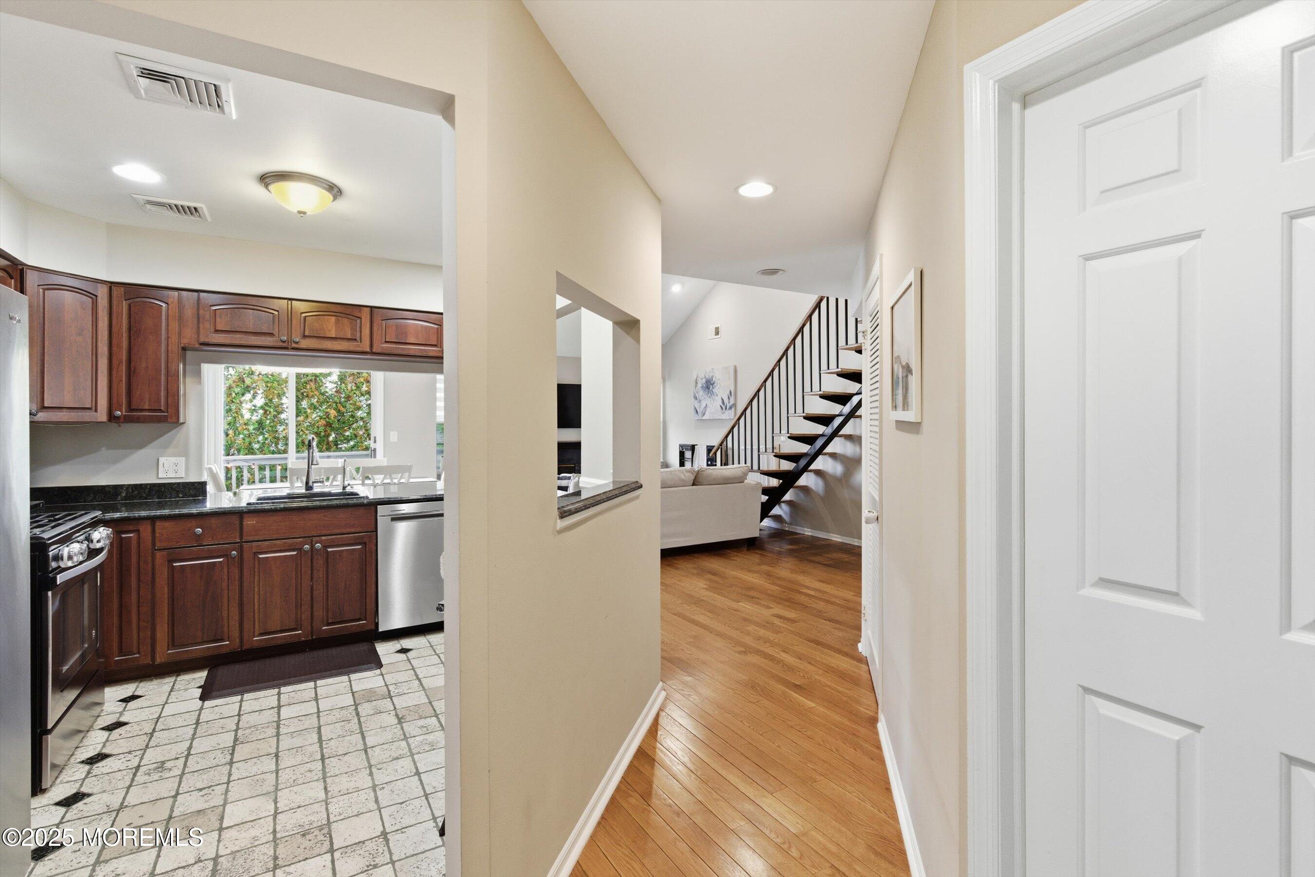 122 Quartz Lane Paterson, NJ 07501 - Photo 22 of 34 a kitchen with granite countertop a refrigerator and a stove top oven