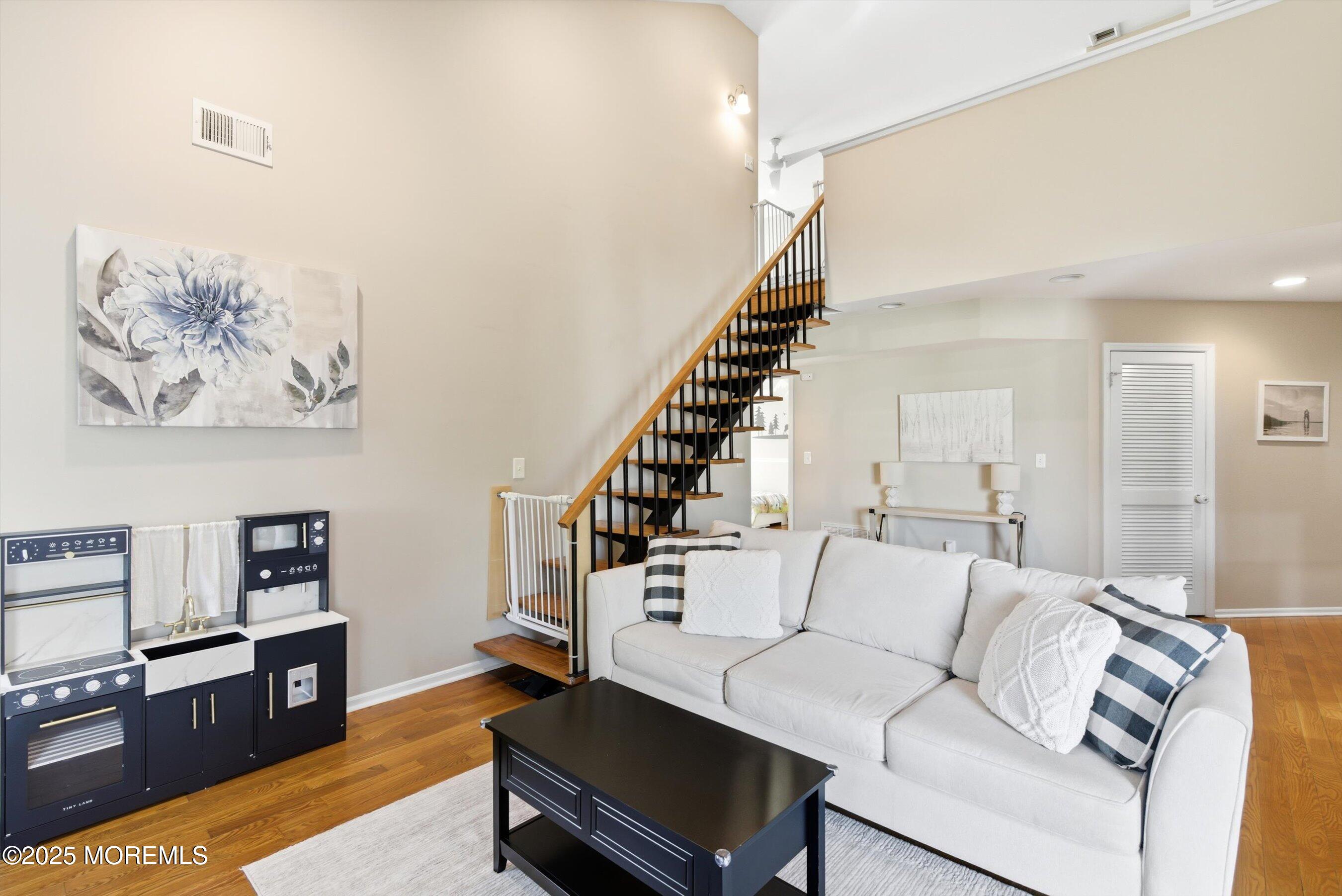 122 Quartz Lane Paterson, NJ 07501 - Photo 7 of 34 a living room with furniture and wooden floor