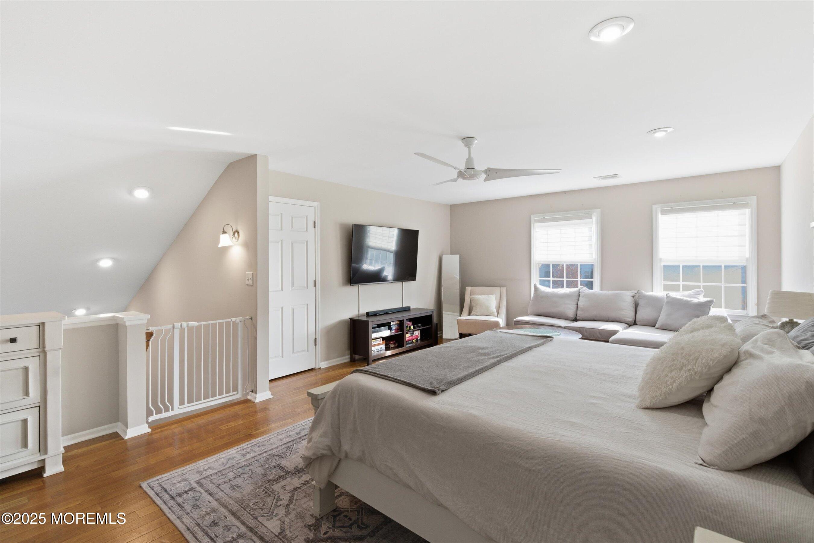 122 Quartz Lane Paterson, NJ 07501 - Photo 9 of 34 a large bedroom with a bed and a flat screen tv