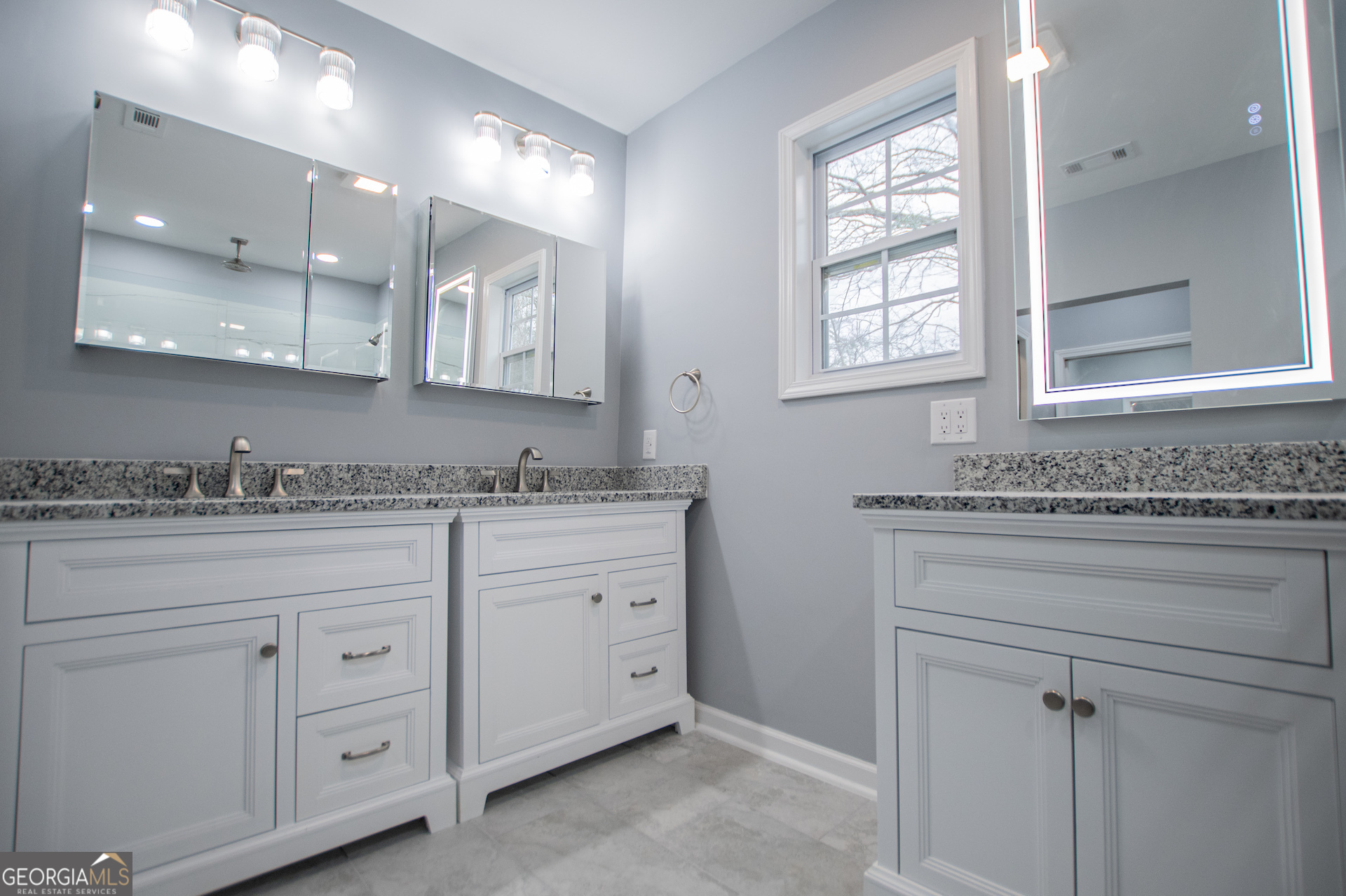 74 Jiles Road Carrollton, GA 30117 - Photo 40 of 130 a bathroom with a granite countertop sink mirror and cabinets