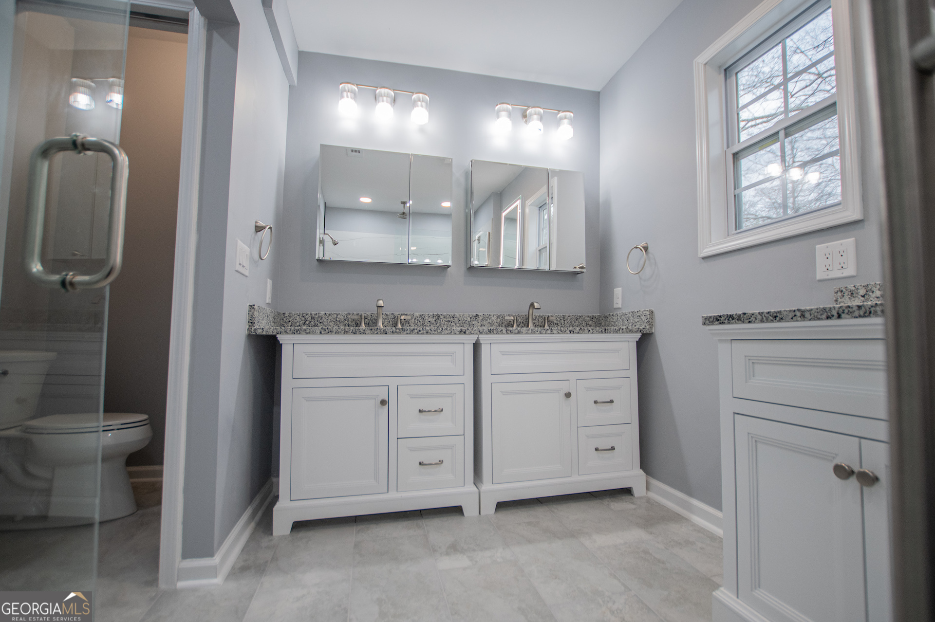 74 Jiles Road Carrollton, GA 30117 - Photo 42 of 130 a spacious bathroom with a granite countertop sink mirror and toilet