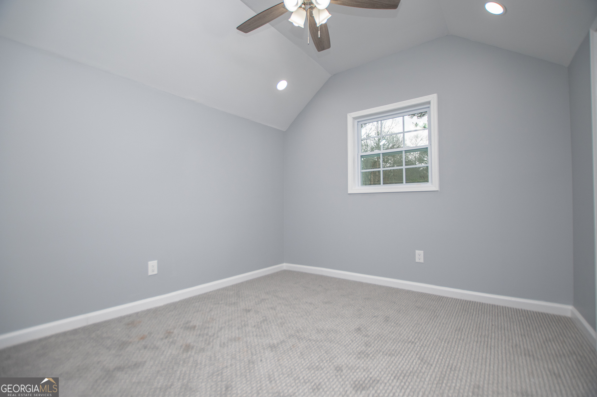 74 Jiles Road Carrollton, GA 30117 - Photo 56 of 130 an empty room with a window and a fan