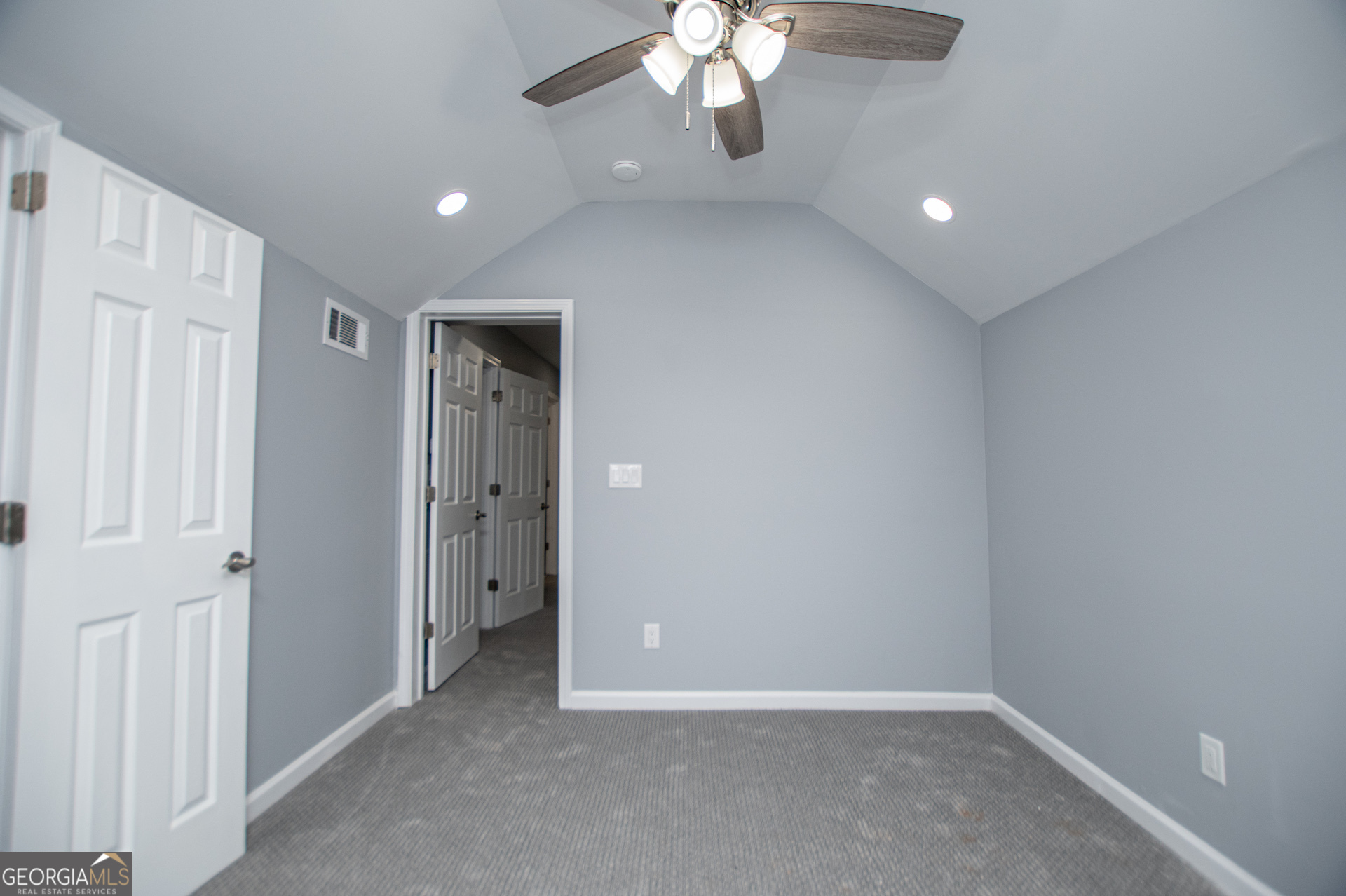 74 Jiles Road Carrollton, GA 30117 - Photo 58 of 130 an empty room with a bathroom and a chandelier fan