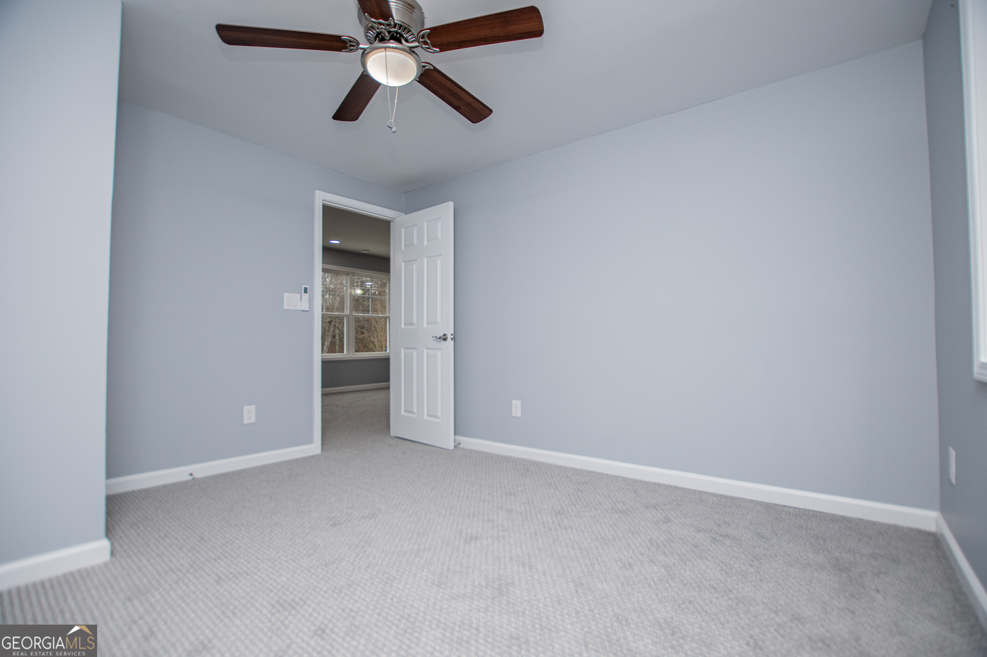 74 Jiles Road Carrollton, GA 30117 - Photo 60 of 130 an empty room with closet and a ceiling fan