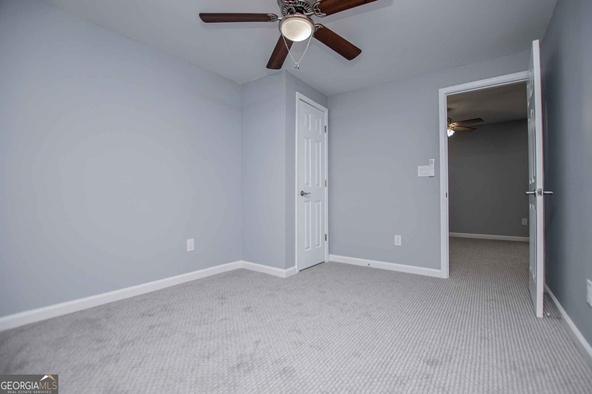 74 Jiles Road Carrollton, GA 30117 - Photo 61 of 130 an empty room with closet and a chandelier fan