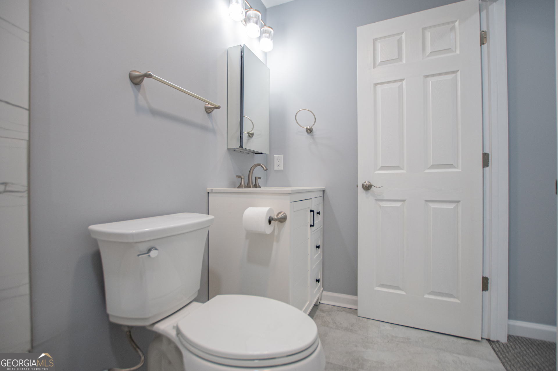 74 Jiles Road Carrollton, GA 30117 - Photo 82 of 130 a white toilet sitting next to a bathroom sink