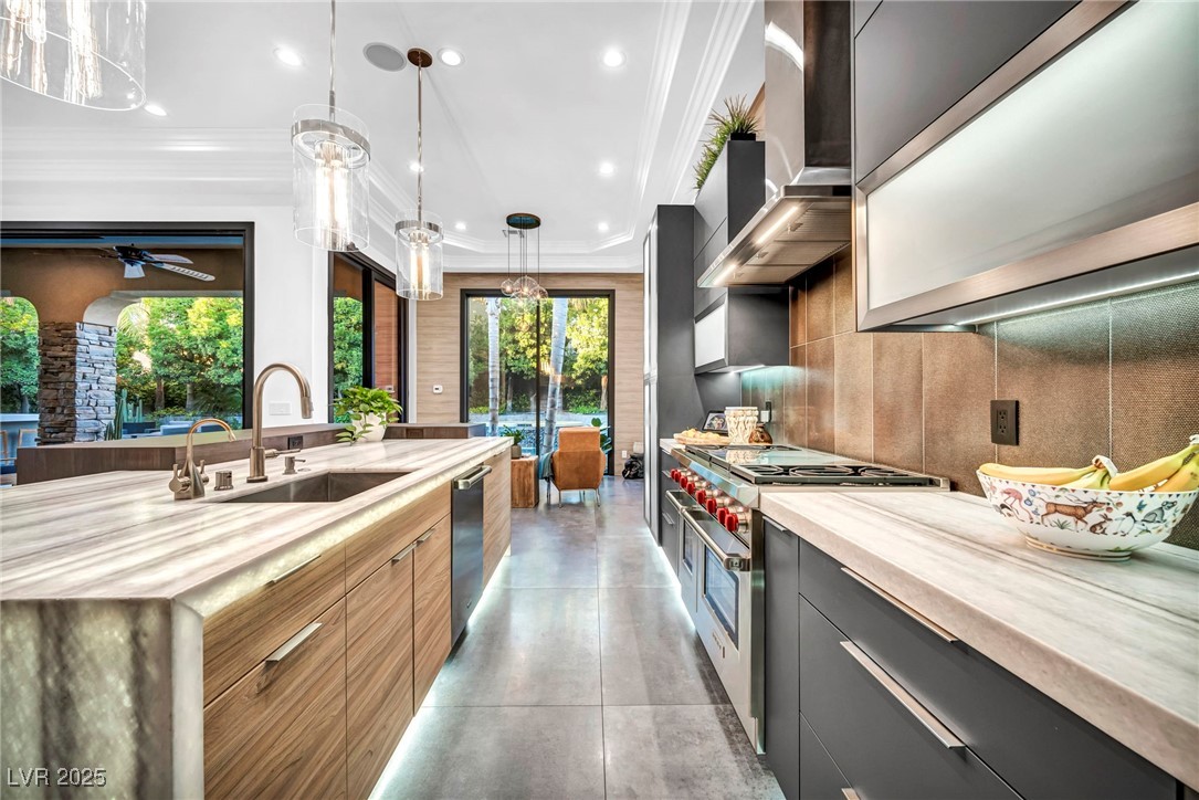 8032 Spring Buck Court Las Vegas, NV 89129 - Photo 18 of 41 Kitchen featuring modern cabinets, hanging light fixtures, stainless steel appliances, crown molding, and recessed lighting
