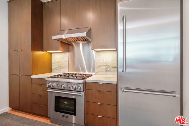 a kitchen with a stove and a refrigerator