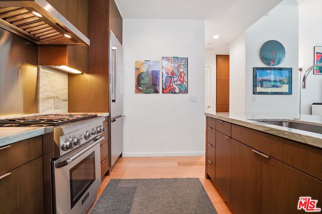 a kitchen with stainless steel appliances a stove and a sink