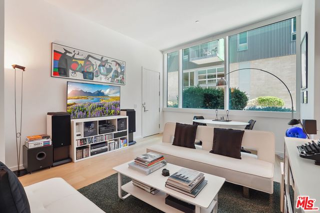 a living room with fireplace furniture and a flat screen tv