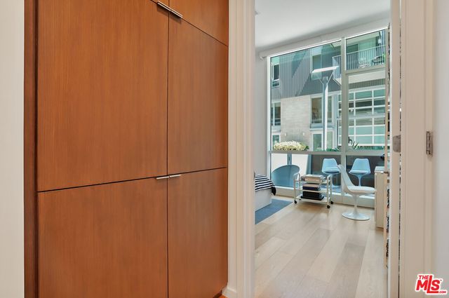 a view of a balcony with a bench and floor to ceiling window