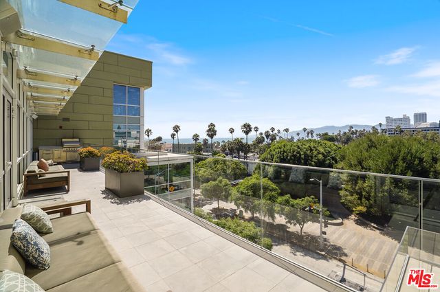 a balcony with chairs and iron fence